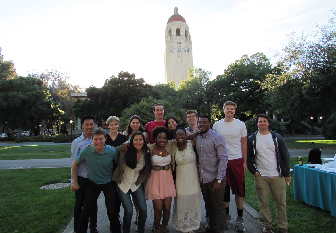Exterior, smiling students in foreground, Hoover Tower in background